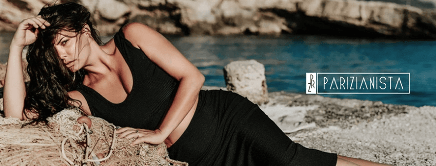 Maria Korinthiou in black dress lying on fishnet on rocks for parizianista.gr | YouBeHero
